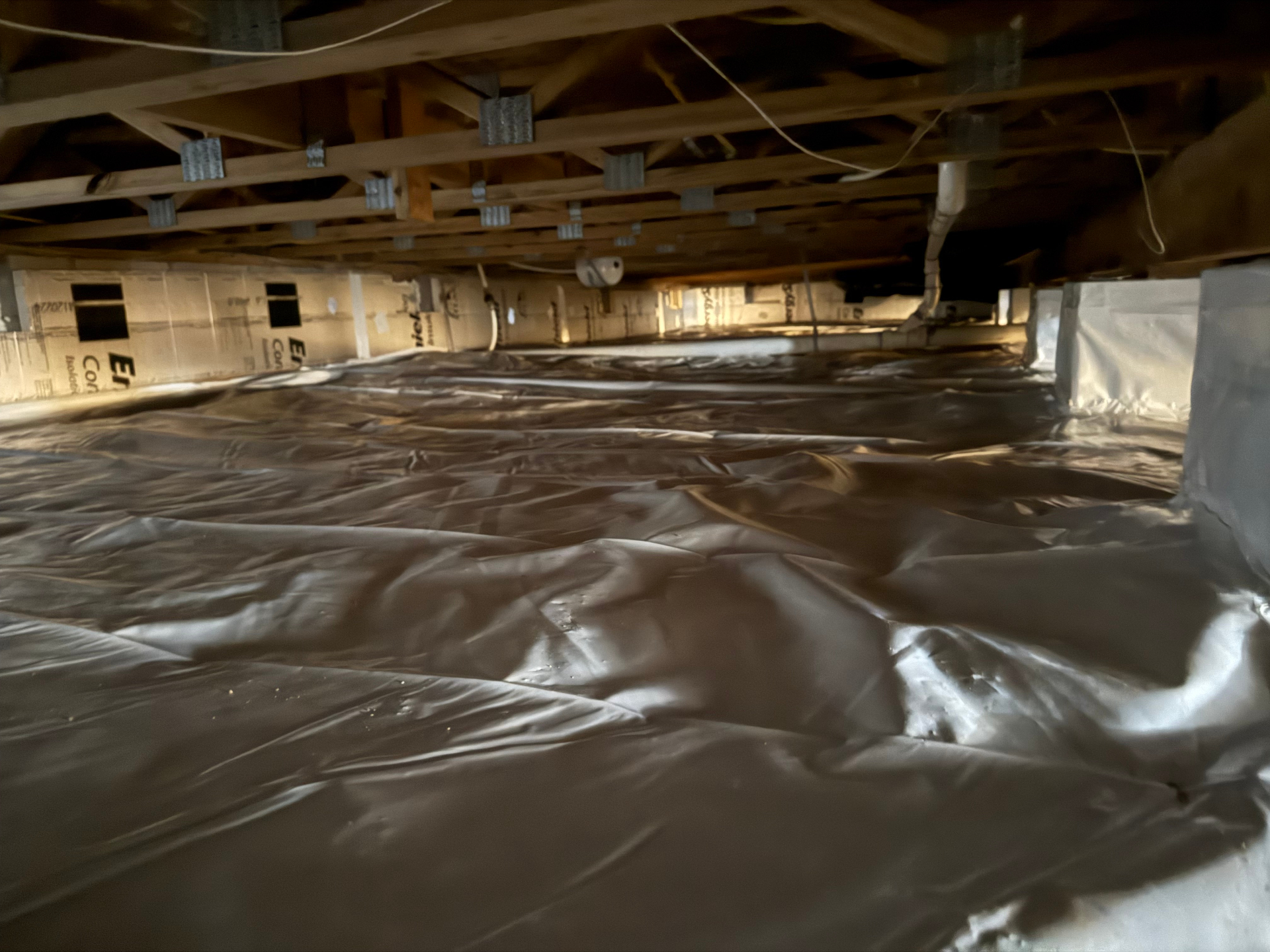 Clean encapsulated crawl space with vapor barrier in Raleigh NC