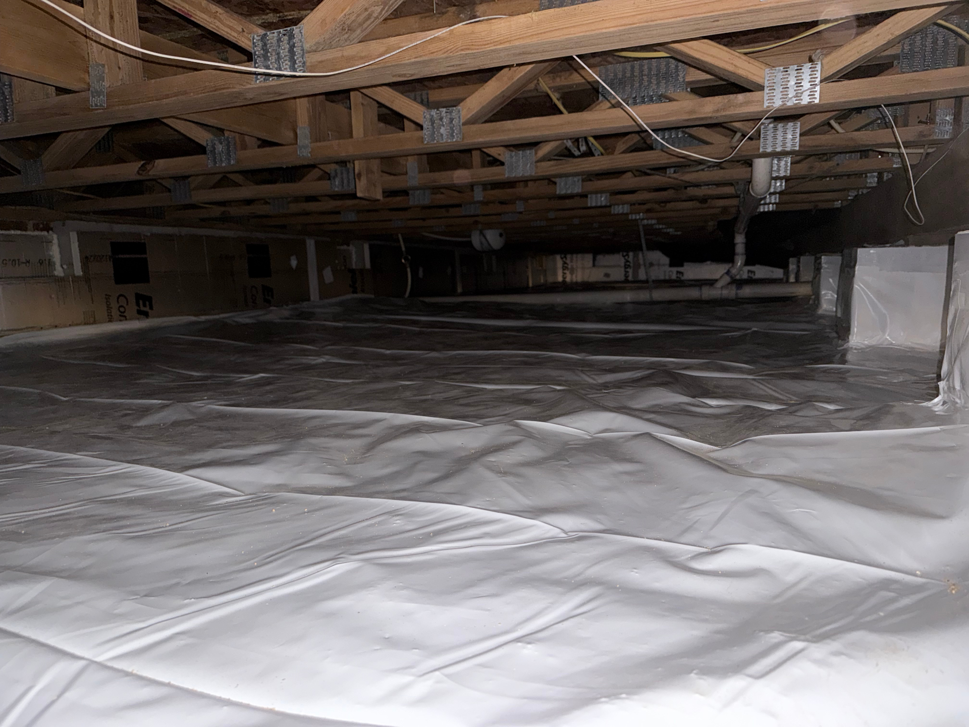 Professionally encapsulated crawl space with sealed vapor barrier